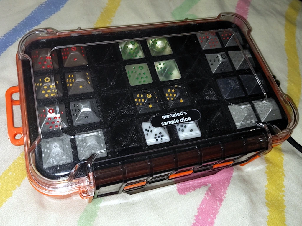 Tactix case closed with dice visible through transparent lid.