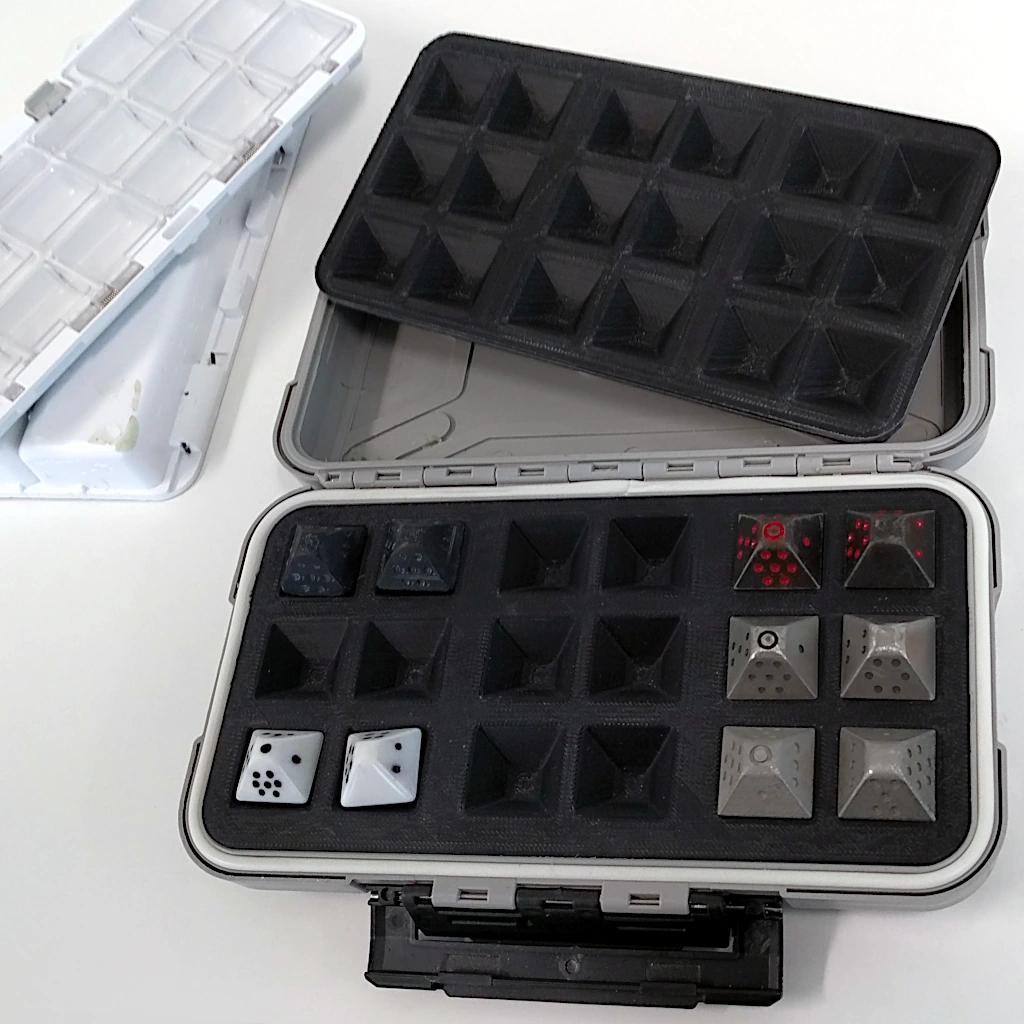 Tackle box with dice inserts holding some dice.