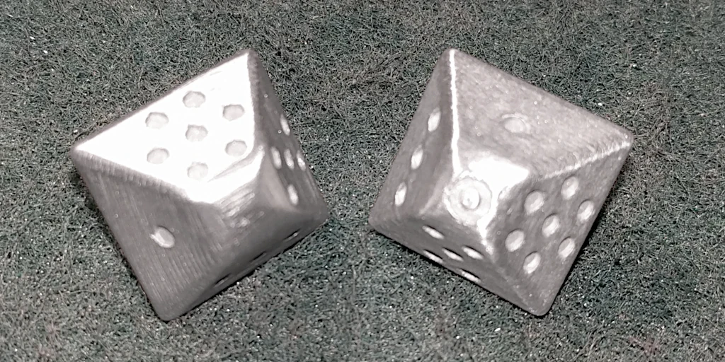 Aluminium dice on the skotch-brite pad I polished them with.