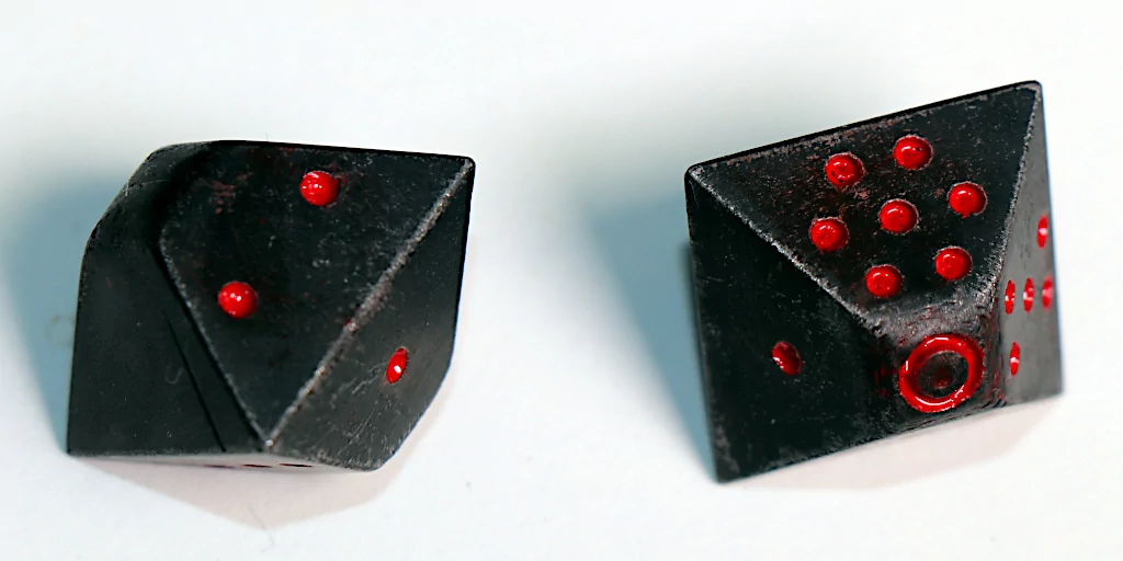 Chemically-blackened dice, hand-painted dots.