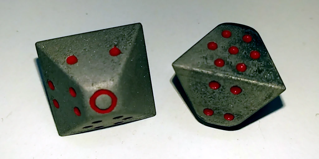 Sand-blasted dice with hand-painted dots.